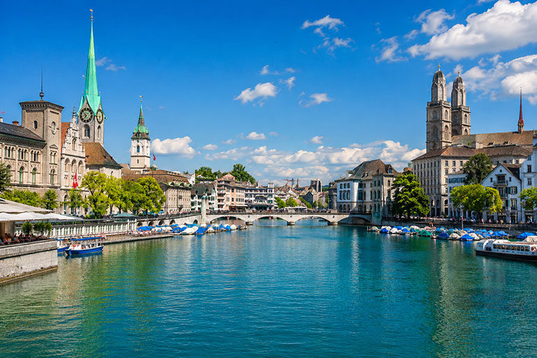 Zurich's Limmat riverfront with the Fraumünster and Grossmünster church towers and moored boats (AI Art)